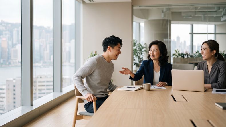 Three colleagues talking around a bright meeting table