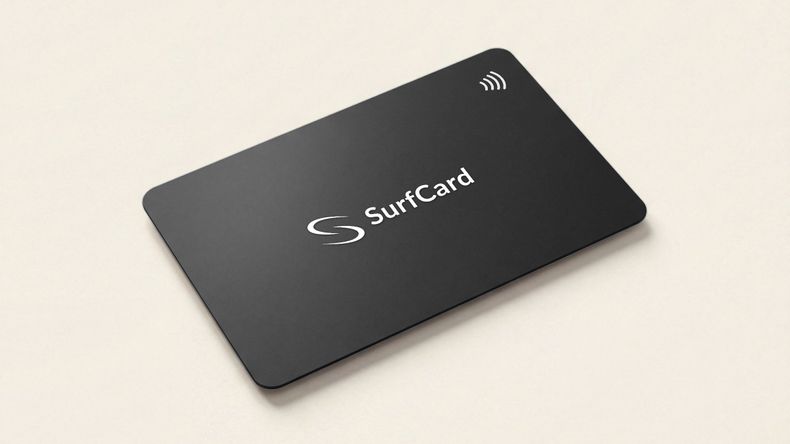 The SurfCard Classic on a pale studio surface — a matte black card carrying the SurfCard mark and the contactless indicator