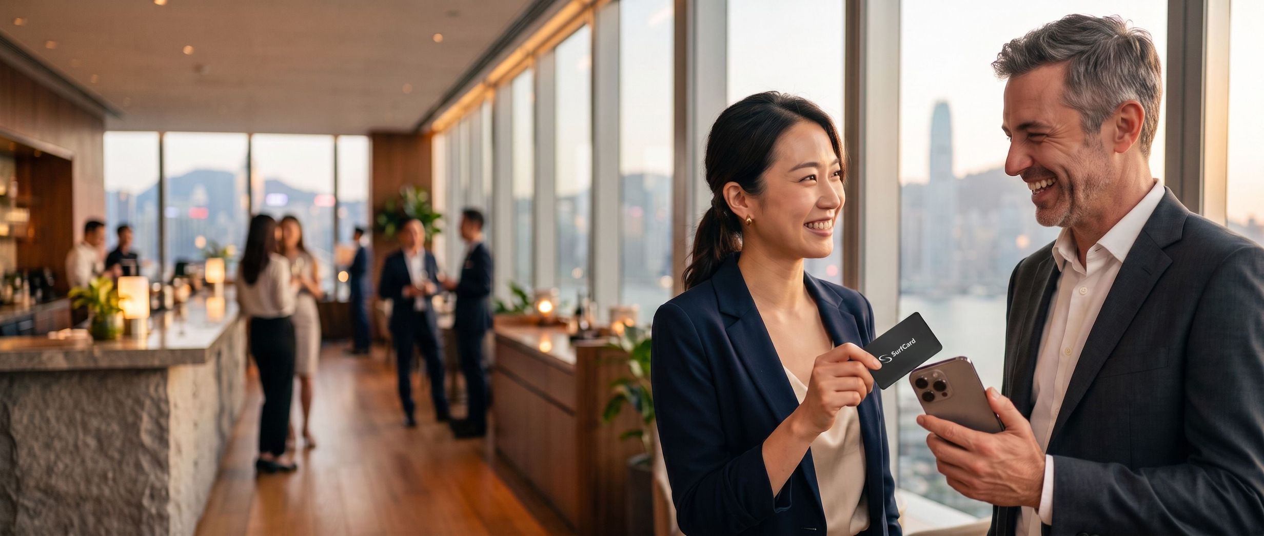 At a Hong Kong networking reception, a professional shares her profile by holding her card to another guest’s phone.