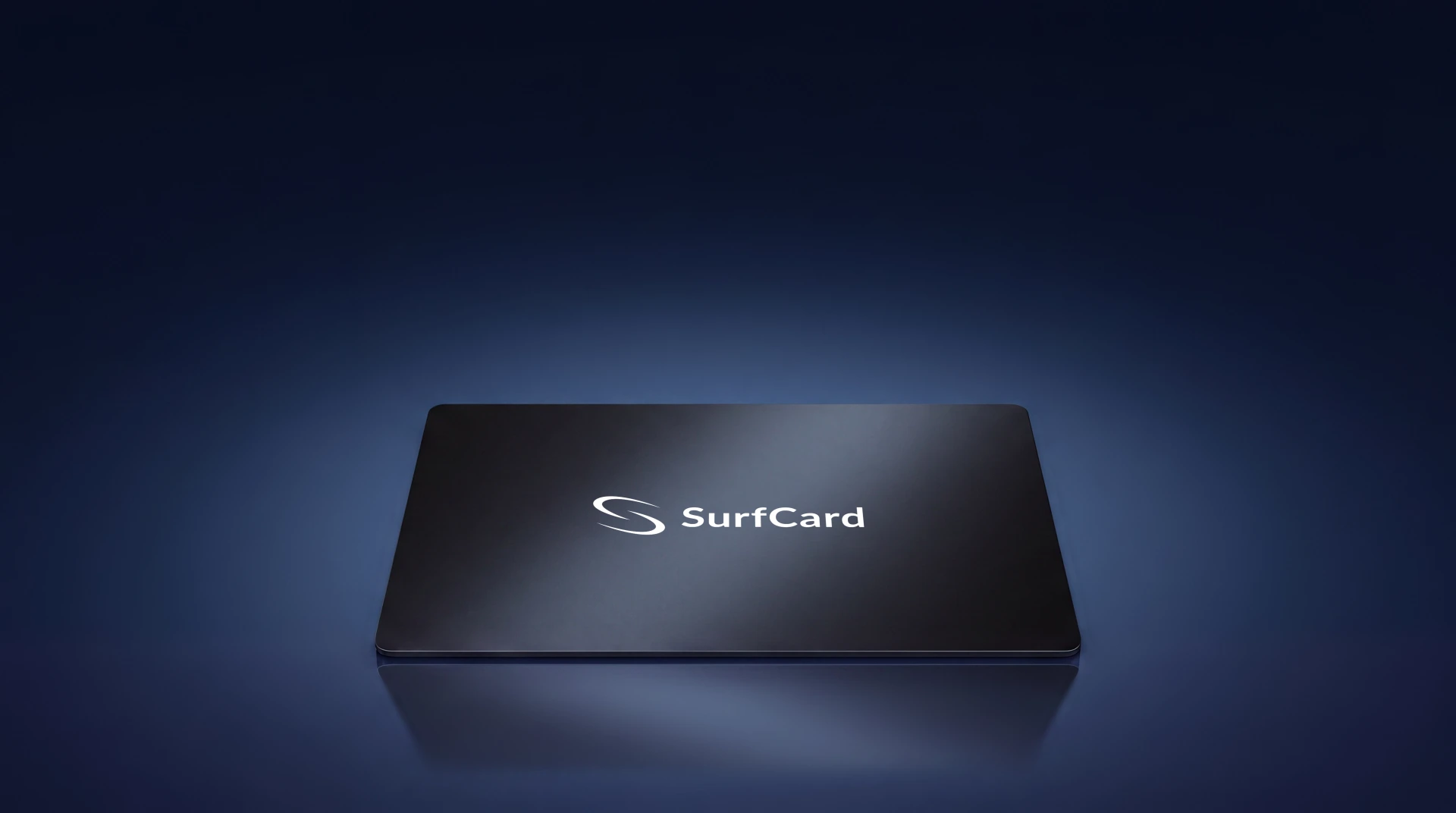 A matte black SurfCard lying on still deep-navy water, mirrored in the surface below